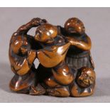 Japanese wood netsuke, 19th century, four men fighting, one on the ground holding on to another