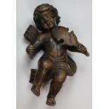 Continental carved wood figural sculpture of a putto, depicted playing a musical instrument, 18"h