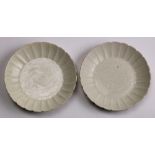 (lot of 2) Chinese Ding-type ceramic dishes, each with a foliate rim and molded petal form walls,