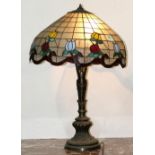 Large Tiffany style leaded glass table lamp, having a domed shade with floral decoration, above a