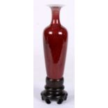 Chinese ox blood glazed porcelain amphora, the trumpet neck set above the tapering body, base with