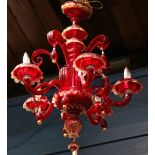 Pair of Venetian Murano chandeliers, executed in crimson, having tear form drops surmounting the