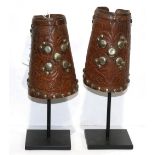 Leather wrist cuffs, early 20th century, hand stamped leather with brass tack design, on a custom