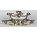 French sterling silver double-lipped sauceboat with attached undertray, having acanthus and ribbon