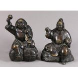 (lot of 2) Japanese patinated bronze gods, featuring Daikokuten, seated on rice bales, sack over his