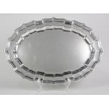 Cartier sterling silver oval platter, having a shaped rim executed in the "Chippendale" style, total