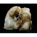 Chinese hardstone carving, of a recumbent sheep clasping a lingzhi sprig, accompanied by a child,