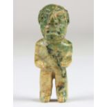 An Olmec or Olmec-style green jadeite figurine, standing on flat-bottomed feet with his hands on