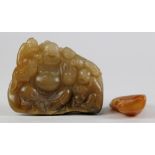 (lot of 2) Chinese soapstone carvings: the first of a small boulder with Budai along with bats;