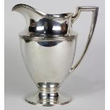 Tiffany & Co. sterling silver water pitcher 1907-1947, having reeded decoration at shoulder, and