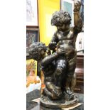 Continental style patinated figural sculpture of a nude putti, rising on a naturalistic base,