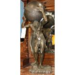 Classical style bronze figural sculpture of Atlas, depicted carrying the world, and rising on a