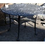 Black painted metal bistro table, having a plate glass top and rising on claw and ball feet, 26.5"h