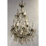 Continental six light chandelier, having crystal prisms and rosette accents suspended from the six