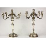 Pair of silver plate Rococo-style candelabra, eaching having four arms, the scrolled arms each issue