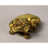 Chinese gilt bronze sculpture, the single-horn mythical beast with large bulging eyes, seated in