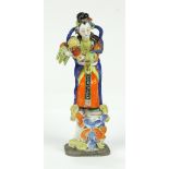 Chinese enameled porcelain celestial beauty, standing on clouds and pouring flowers out of a basket,