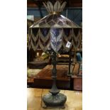 Art Nouveau style table lamp, having a sculpted patinated metal base, with a stained glass shade,