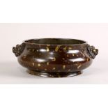 Chinese patinated bronze censer, the compressed low slung body flanked by lion-head handles and