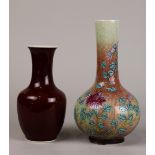 (lot of 2) Chinese porcelain vases, the first of ox blood glaze with a trumpet neck and tapering