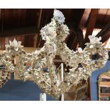 Grotto style custom shell encrusted chandelier, each of the five arms covered in various styles of