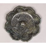 Chinese metal mirror, with a foliate rim framing floral sprigs and centered by birds amid