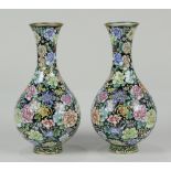 (lot of 2) Chinese Canton enameled mille fleur vases, each with a trumpet form neck on a pear shaped