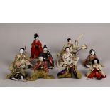 (lot of 10) Japanese traditional hina dolls, some carrying a sword or bow, all in silk robes,