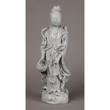 Chines blanc de chine Guanyin, standing above cresting waves, holding a basket with a fish, the back