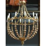 Custom hammered brass chandelier, having ten lights surmounting the spherical accents continuing