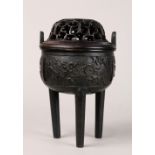 Chinese copper alloy ding-form censer, the body cast with flowering branches, raised on tapering