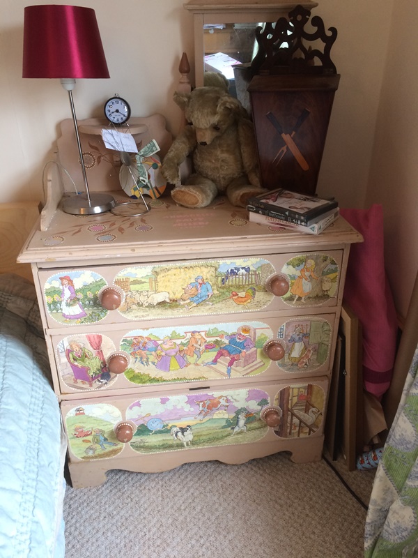 A painted and decorated chest of 3 long drawers