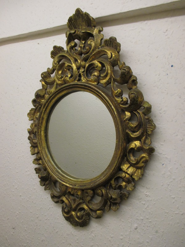 A small carved gilt wood wall mirror