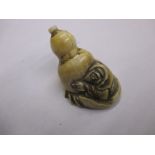 A 19th Century carved ivory Netsuke in the form of a man carrying a gourd, signed to the base