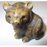 A 19th Century carved ivory Netsuke in the form of a tiger, signed to base