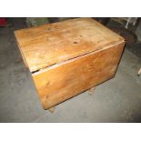 An antique pine drop leaf kitchen table