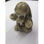 A 19th Century carved ivory Netsuke in the form of a monkey, signed