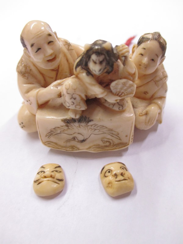 A 19th Century carved ivory Netsuke in the form of 2 puppeteers, still retaining the original