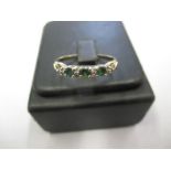 A 9ct gold diamond and emerald ring