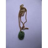 An 18ct gold necklace with jade pendant, approx. weight of chain 6g