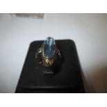 An unmarked Dubai gold ring set with central aquamarine