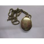 A Victorian yellow metal locket and chain