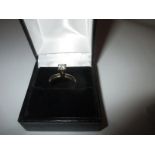 An 18ct yellow gold high set diamond solitaire ring