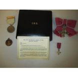 A boxed ladies OBE medal with miniature along with the 1914-18 Red Cross war services medal and