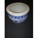 A large blue and white ceramic jardinière pot