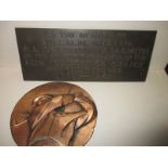 A bronze Sun insurance plaque commemorating those who gave their life in WWII and a golfing plaque