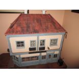 A vintage dolls house with fitted interior