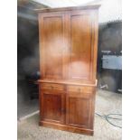 A late 19th century oak bookcase on cupboard base