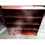A low fixed shelf mahogany bookcase