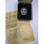 An 18ct gold cameo brooch with diamond set surround